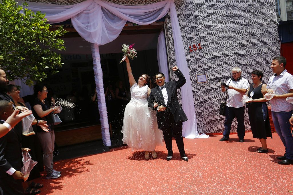 Una pareja festeja tras casarse en una ceremonia colectiva de parejas del mismo sexo en Sao Paulo, Brasil, el sábado 15 de diciembre del 2018. (AP Foto/Nelson Antoine)