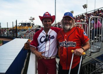 Two fans wearing Cuban baseball shirts.