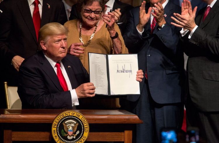 Donald Trump shows the presidential memorandum on the Cuba policy at the end of his speech at the Manuel Artime Theater of Little Havana, in Miami. Photo: Cristobal Herrera / EFE.