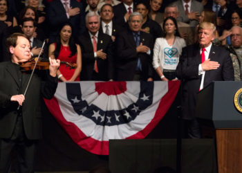 Cuban violinist Luis Haza plays the U.S. national anthem during Donald Trump’s speech at the Manuel Artime Theater, Friday June 16. Photo: Cristobal Herrera / EFE.