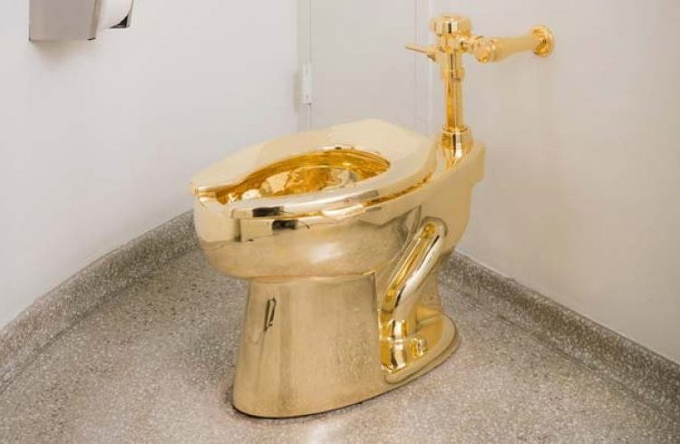 The 18-karat toilet titled “United States” is a criticism by Maurizio Cattelan of the nation’s greedy instincts.
