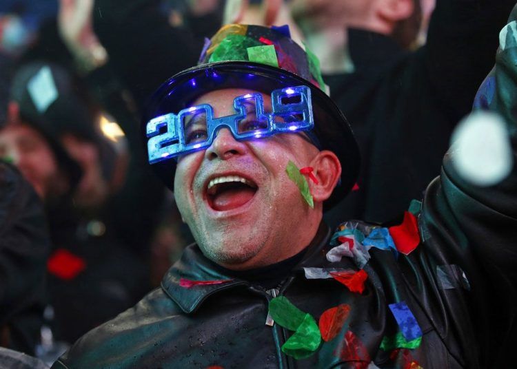 A man celebrates the arrival of 2019 under a shower of confetti during the New Year’s Eve celebration in Times Square, New York, on January 1, 2019. (AP Photo / Adam Hunger)