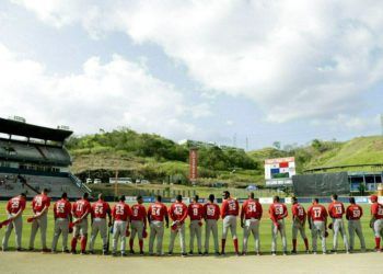 Players of the Cuban Las Tunas Leñeros team listening to their national anthem before facing Panama’s Los Toros de Herrera in the finals of the Caribbean Series at the Rod Carew Stadium in Panama City, on February 10, 2019. Photo: Arnulfo Franco/AP.