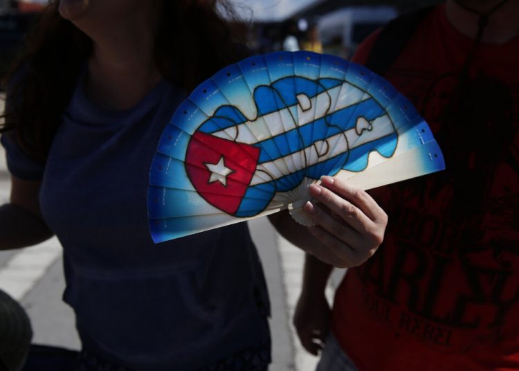 Bobbie Bryant, 41, from Orlando, holds a fan that he bought in Cuba upon his arrival to Port Everglades in Fort Lauderdale, Florida, on Wednesday, June 5, 2019. (AP Photo/Brynn Anderson)
