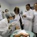 Cuban doctors observe a dental procedure during a training session at a health clinic in Brasilia. Photo: Eraldo Peres / AP.