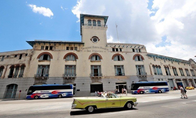 Several cars pass in front of the Havana cruise terminal. Photo: Ernesto Mastrascusa / EFE.
