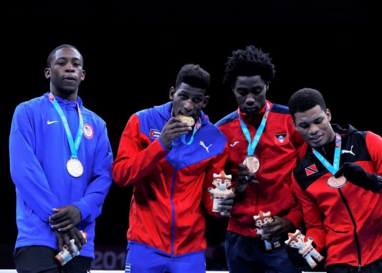 Cuban Andy Cruz (2-l) poses alongside U.S. silver medalist Keyshaw Davis (l) and bronze medalists Conrand Ryan (2-r) from Antigua and Barbuda and Michael Alexander from Trinidad and Tobago, this Friday at the lightweight awards ceremony in men's boxing at the Lima 2019 Pan American Games (Peru). EFE / Christian Ugarte
