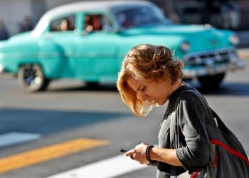 A woman uses her cell phone this Friday, December 6, 2019, in Havana, one year since the activation of mobile internet in Cuba. Photo: EFE / Yander Zamora.