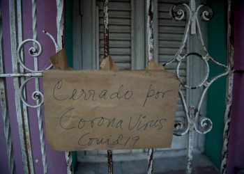 A sign saying “Closed for coronavirus COVID-19” hangs on the window of a business in Havana, Cuba, on Friday, April 24, 2020. (AP Photo/Ismael Francisco)