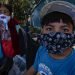 Esperanza Miranda and her grandson wear facemasks to protect themselves from contagion on June 17, 2020 in Immokalee, in South Florida. At the cost of their health, thousands of Mexican and Central American immigrants who are declared “essential” managed to collect this year’s harvest in Immokalee, the tomato capital of the United States and now also one of the hottest spots for the COVID-19 in Florida. Photo: Giorgio Viera/EFE.
