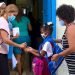 An educator applies a disinfectant to a girl’s hands at the entrance to her school in Havana. Photo: Otmaro Rodríguez.