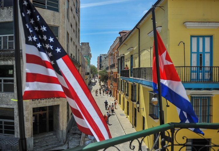 Cuban and U.S. flags on the facade of the La Moneda Cubana Restaurant in Havana. Photo: Yamil Lage/AFP/Getty Images.