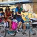 A mother takes her children to school in a pedicab, in Havana. Photo: Otmaro Rodríguez.