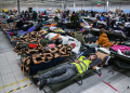 People who fled the war in Ukraine rest in a temporary shelter after being transported from the Polish-Ukrainian border on March 8 in Przemysl, Poland. (Omar Marques/Getty Images)