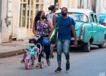 The Family Code. Cuban family walks through the streets of Havana