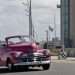 A classic car drives past the U.S. embassy in Havana. Photo: Ernesto Mastrascusa/EFE.