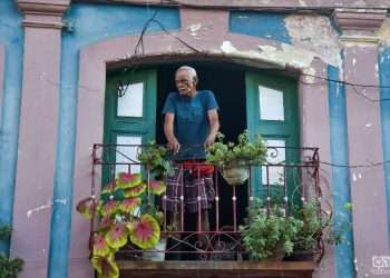 Man on a balcony in Havana. Dollar in Cuba