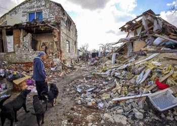 A 49-year-old man, Genadi, shows his neighbors’ destroyed building in Cherkaski Tyshky, Kharkiv region, Ukraine, on March 27, 2023. The Ukrainian army drove Russian forces out of the occupied territory in the northeast of the country in counterattacks in the autumn of 2022. Kharkiv and its surroundings areas have been subjected to intense bombing since February 2022. Photo: EFE/EPA/SERGEY KOZLOV.