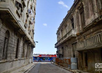 A tourist bus travels along Havana’s Malecón boardwalk, seen from San Lázaro