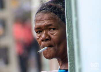 Smoking in Cuba. Cuban women smoke in a Havana doorway