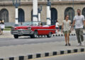 People walk down a street in Havana. Photo: Ernesto Mastrascusa/EFE.