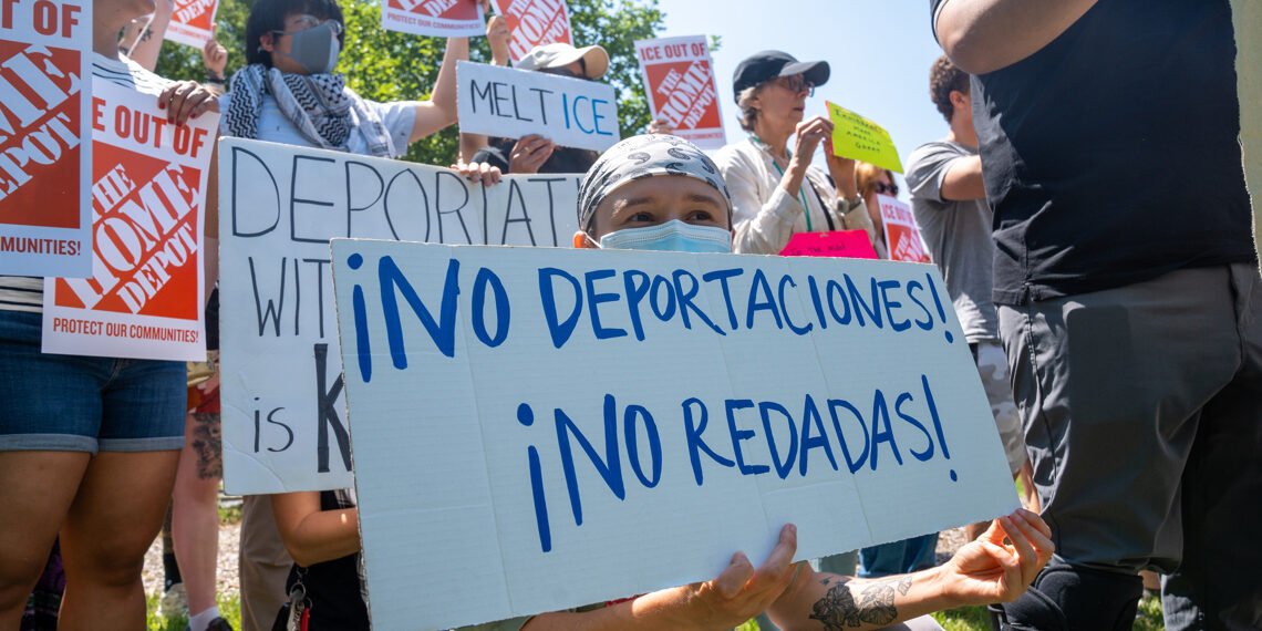 People hold signs during a demonstration in support of the National Day Laborer Organizing Network following the recent ICE raids in The Home Depot parking lot in East Windsor, New Jersey. Photo: EFE/Ángel Colmenares.