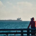 Man observes oil tanker in Cuba