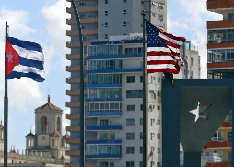 U.S. and Cuban flags flying in front of the U.S. Embassy in Havana