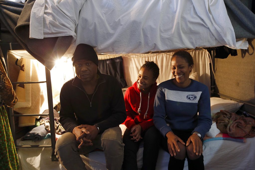Michael Amor, his wife Ingrid and their daughter Samira in a room of the refugee center in Sot, Serbia. Photo: Darko Vojinovic / AP.