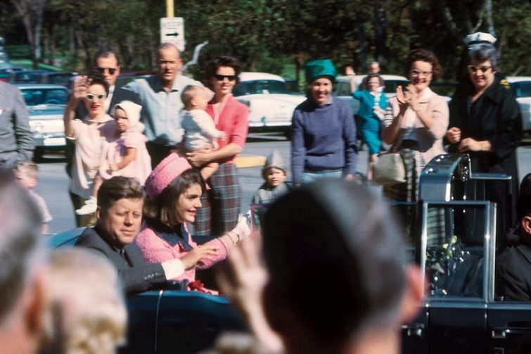 President Kennedy and Jacqueline Kennedy smile at the crowds lining their motorcade route in Dallas, Texas, on Nov. 22, 1963. Minutes later the President was assassinated as his car passed through Dealey Plaza.(Bettmann/CORBIS)