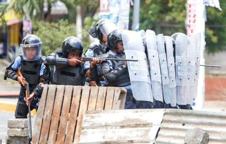 Policía antimotines durante enfrentamientos con manifestantes en Managua, el viernes 20 de abril. Foto: Alfredo Zúñiga / AP.