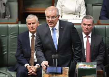 Australian Prime Minister Scott Morrison, center, delivers a formal apology to Australia's victims of child sex abuse in the House of Representatives at Parliament House in Canberra, Monday, Oct. 22, 2018. His emotional speech delivered in Parliament before hundreds of survivors followed the conclusions of a Royal Commission into Institutional Responses to Child Sexual Abuse, the nations' highest level of inquiry. (Mick Tsikas/AAP Image via AP)