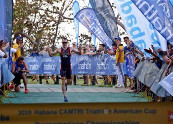 El estadounidense Collin Chartier llega a la meta en primer lugar, en la categoría Elite este sábado, durante el Campeonato Iberoamericano de Triatlón en La Habana. Foto: Ernesto Mastrascusa / EFE.