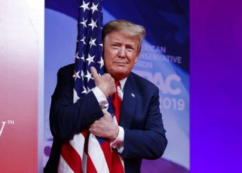 El presidente Donald Trump abraza la bandera estadounidense a su arribo a la Conferencia de Acción Política Conservadora en Oxon Hill, Maryland, donde pronunció un discurso de campaña en el que pronosticó su triunfo en 2020. Foto: Carolyn Kaster / AP.