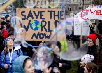 Jóvenes se manifiestan a favor de la adopción de medidas contra el cambio climático con un letrero que dice: "Salven al mundo ahora" durante una concentración en Berlín, Alemania, el viernes 22 de marzo de 2019. Foto: Christoph Soeder / dpa vía AP.