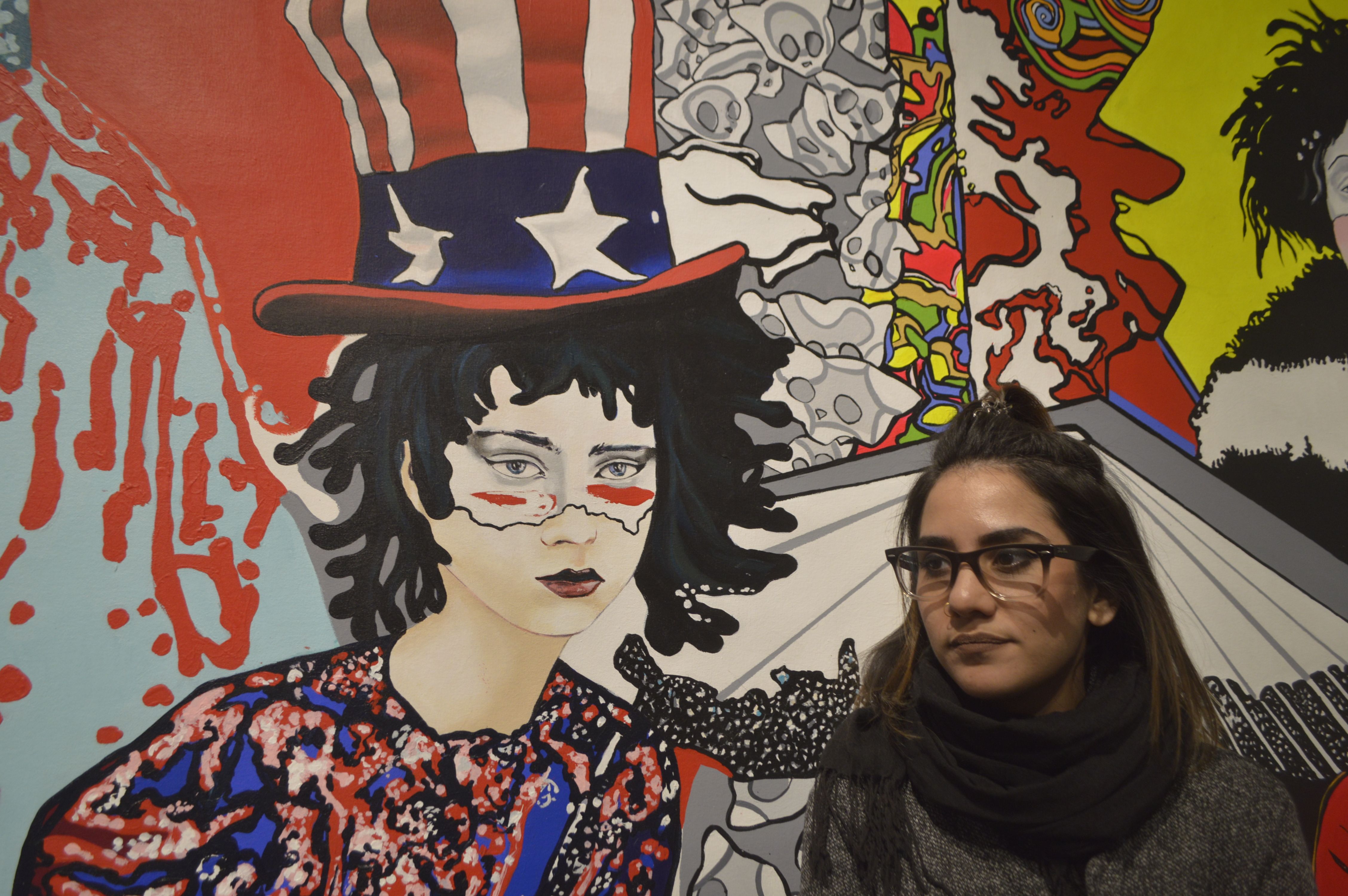 La artista cubana Osy Milian junto a una de sus obras desplegadas en la muestra unipersonal "C' moi, cest nous", en la galería Cheng Xindong de Pekín, en febrero de 2019.