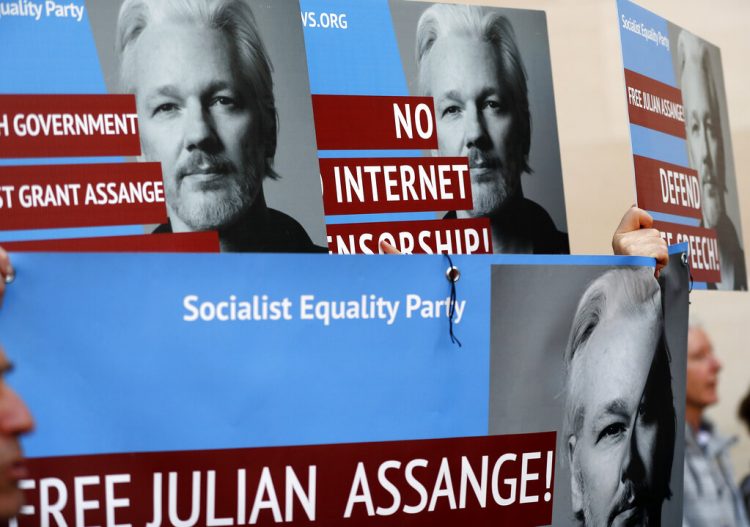 Manifestantes con carteles con la imagen del fundador de WikiLeaks, Julian Assange, protestan en la entrada del tribunal de Westminster, en Londres, el 2 de mayo de 2019. Foto: Frank Augstein / AP / Archivo.