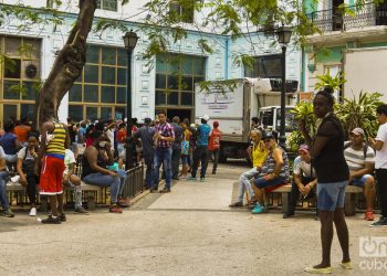 Cubanos hacen una cola en las afueras de un centro comercial en La Habana, en momentos en que el gobierno de la la Isla ha llamado a practicar el aislamiento social como medida para evitar el contagio de la COVID-19. Foto: Otmaro Rodríguez.