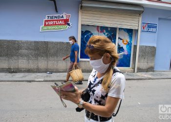 Dos personas caminan usando mascarillas e La Habana, como protección ante la pandemia de coronavirus. Foto: Otmaro Rodríguez.