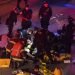 Trabajadores de emergencias atienden a una persona herida tras un atropello en una protesta en la Interestatal 5 en Seattle. Dawit Kelete, de 27 años, fue detenido y acusado de dos delitos de agresión con vehículo, según las autoridades. (James Anderson via AP)