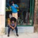 Una mujer revisa su teléfono móvil en las afueras de una tienda que se prepara para su reapertura, tras la flexibilización de las restricciones por la COVID-19 en La Habana. Foto: Otmaro Rodríguez.