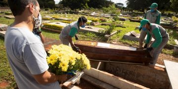 Empleados preparan a víctimas mortales de la COVID-19 para ser enterradas en el cementerio de Campo da Esperança, en Brasilia (Brasil). Foto: Joédson Alves / EFE / Archivo.