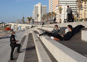 Policías interroga a personas en la playa durante un cierre nacional en Tel Aviv. Foto: ABIR SULTAN/EFE/EPA/