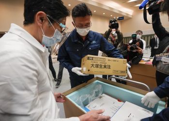 Personal de un hospital de Tokio revisa la temperatura de las vacunas contra el coronavirus de Pfizer, el martes 16 de febrero de 2021. Photo: Kimimasa Mayama/Pool/AP.