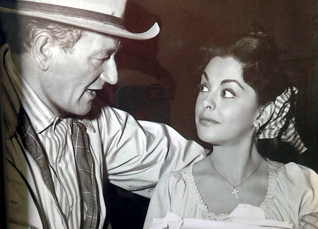 Fotografía cedida donde aparece la actriz cubana Estelita Rodríguez hablando con el actor John Wayne, con quien se hizo amiga durante el rodaje de "Río Bravo" (1959). Foto: EFE/Nina López/Serena Burdick.
