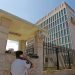 Un guarda de seguridad habla por teléfono frente al edificio de la embajada de EEUU en La Habana. | Reuters