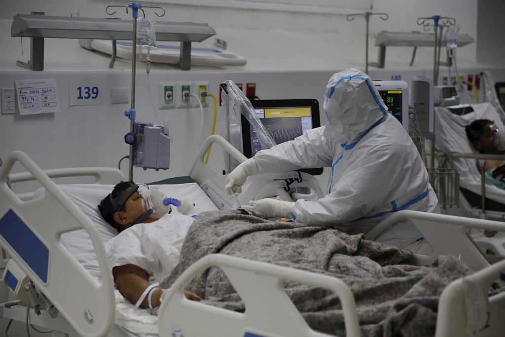 Un enfermero atiende a un paciente en la Unidad de Cuidados Intermedios para pacientes covid-19 del Hospital El Salvador, en San Salvador (El Salvador). Foto: EFE/Rodrigo Sura/Archivo.