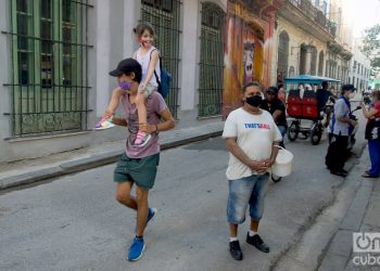 Un hombre carga en hombros a su hija, en una calle de La Habana. Foto: Otmaro Rodríguez.