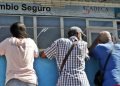 Varias personas esperan afuera de una casa de cambio (CADECA), con la intención de comprar divisas, en La Habana, el 23 de agosto de 2022. Foto: Ernesto Mastrascusa / EFE.