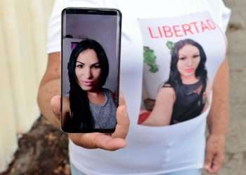 La madre de la trans cubana Brenda Díaz, detenida y enjuiciada por su participación en las protestas antigubernamentales del 11 de julio de 2021 en Cuba, muestra una foto de su hija. Foto: Ernesto Mastrascusa / EFE / Archivo.